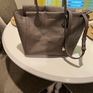 This Michael Kors bag is 15 wide and 10 inches long.